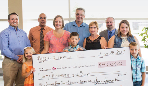 Biadasz family behind a giant check