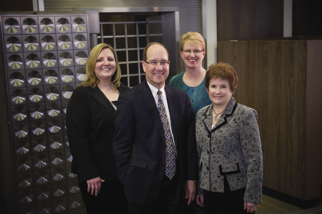 Associated Bank staff in MarshḀeld includes (from left) Theresa Zirbel O’Neel, senior bank manager; John Baur, community bank president; Peggy Davis, corporate loan review officer; and Nancy Kautza, commercial loan sales and service support specialist.