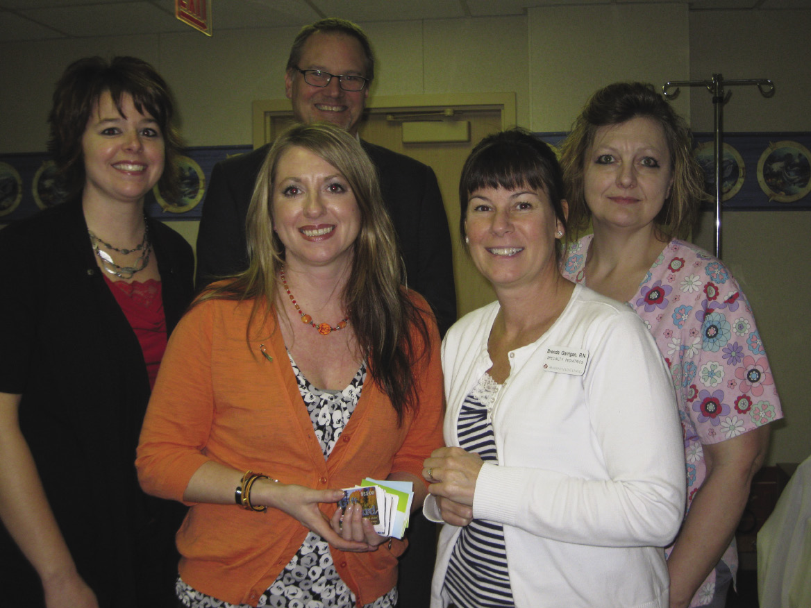 Becky Krause (front left) presented gift cards to Brenda Garrigan. R.N., as (back row, from left) Angie Kelnhofer, Dave Krause and medical assistant Danine Sell look on.