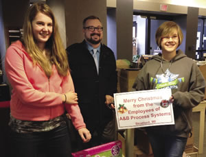 : Representatives of A & B Process Systems, along with Development Officer Matt Faber, deliver donated items to the Clinic. 