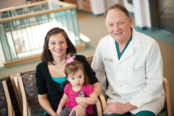 A smiling Dawn Cahill and her daughter, Brianna, meet with Dr. Bruce Thomas.