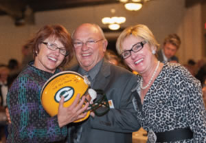Enjoying the Auction were (from left) Dr. Susan Turney, Marshfield Clinic Health System CEO, Floyd Hamus (who bought the Clay Matthews Packers helmet) and Dr. Ann Smith.