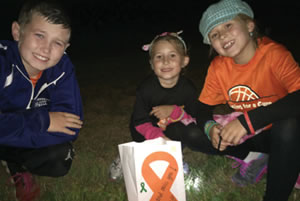 Families honored their loved ones by creating luminary bags at the Junction City Candle Light Cancer Walk.