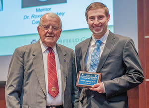 Thomas Nikolai, M.D., (left) emeritus physician, presents the Nikolai Award for Outstanding Resident Research to Victor Abrich, M.D., Internal Medicine resident, at the 2014 Medical Education Day