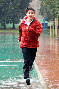 young athletic woman jogging in the rain
