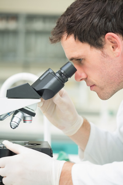 Man looking in microscope