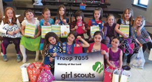 Haley and her troop pose with their goodies for the Pediatric Oncology treasure chest at Marshfield Clinic.